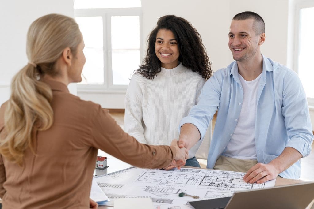 Selling your home? Here's a photo of a realtor congratulating couple on selling their home.