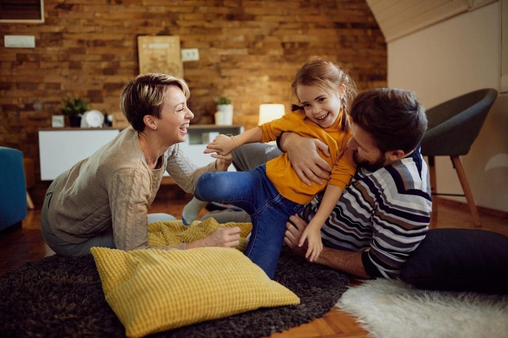 Mother and father enjoying time with their young daughter in their new Lease to Own Home in Raleigh NC.