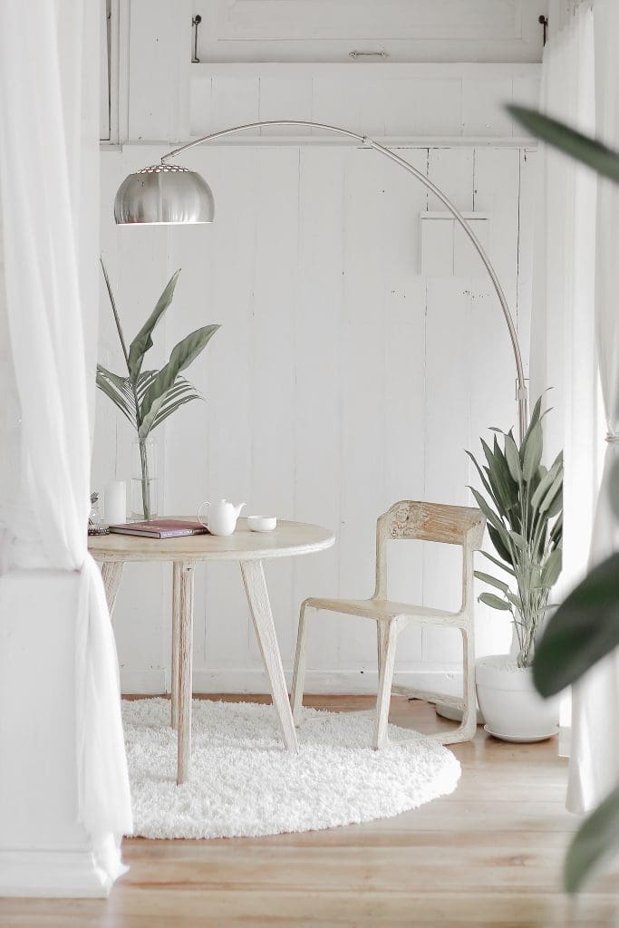 Table and chair in a cozy corner nook of a brightly-lit Lease to Own home in Raleigh, NC