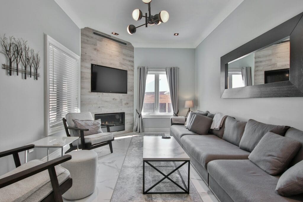 
A modern living room with a sleek gray and white aesthetic, featuring stylish furniture and a cozy ambiance. Raleigh real estate that offers innovative options like the lease to own home program, providing a smarter and more flexible path to homeownership.