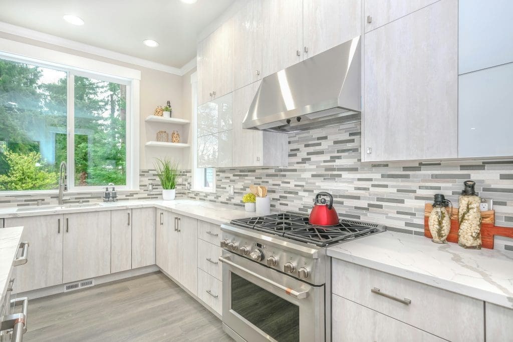 Modern, bright kitchen with stainless steel appliances, quartz countertops, LVP flooring in an equity-building lease to own home in Raleigh, NC