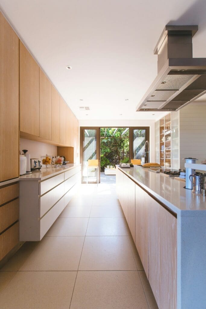 A spacious kitchen setup with a warm brown and white theme, featuring ample counter space and modern finishes. This inviting kitchen is perfect for a first time buyer, offering a functional and elegant space to create lasting memories in their new lease-to-own home.