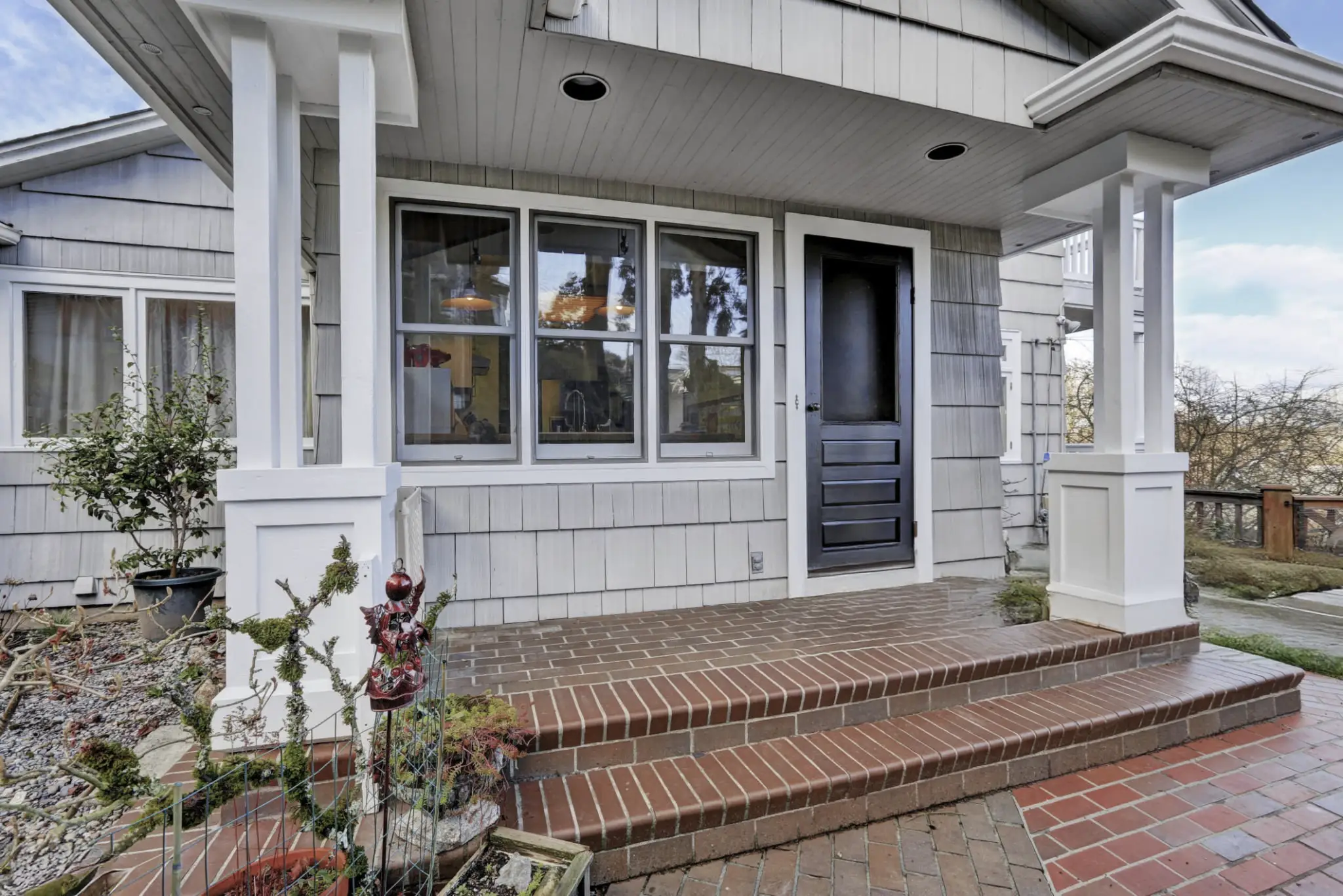 Lease to Own Greensboro porch entrance with brick tile floor and black door