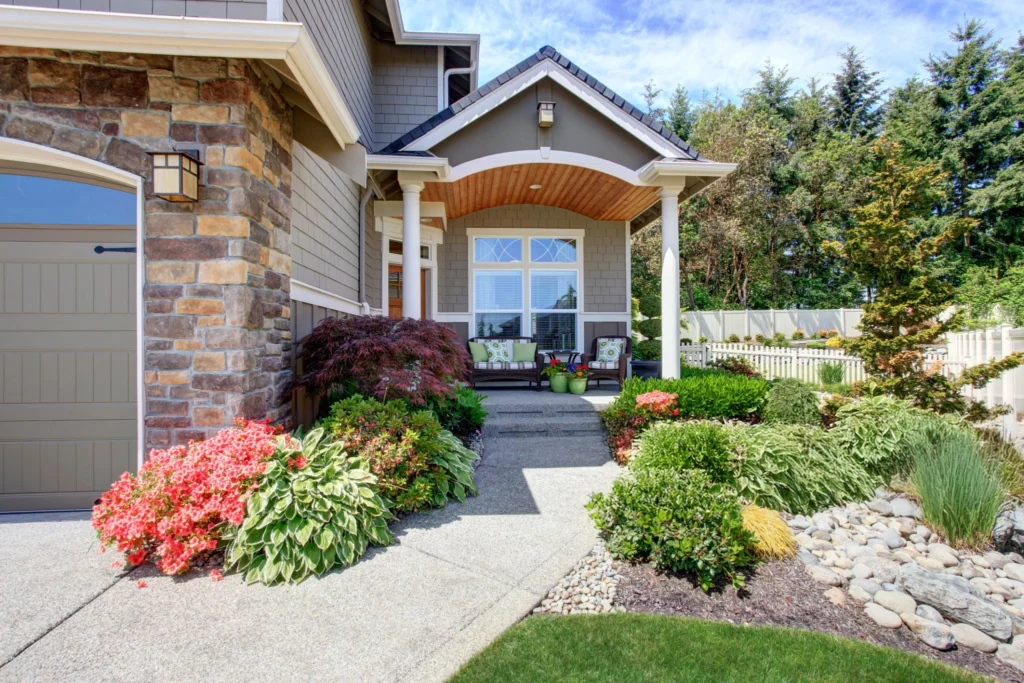 Brick porch entrance with pine trees of a lease to own Greensboro home.