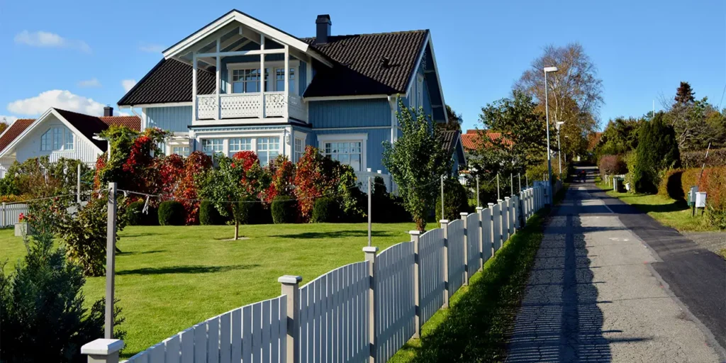 Beautiful Raleigh NC neighborhood featuring a well-maintained home with landscaped yard and white fence, representing safe lease to own and rent-to-own homes options without scam risks.